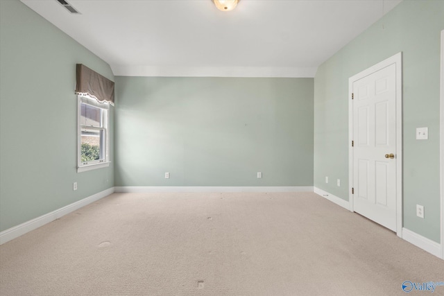 unfurnished room featuring light colored carpet