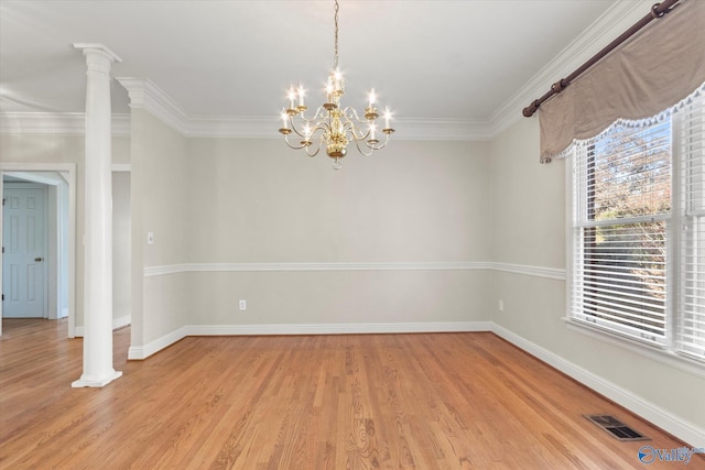 unfurnished room featuring ornate columns, crown molding, light hardwood / wood-style flooring, and a chandelier