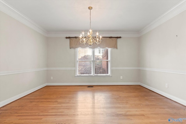 empty room with light hardwood / wood-style floors, crown molding, and a notable chandelier