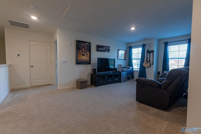 carpeted living area with attic access, baseboards, visible vents, and recessed lighting