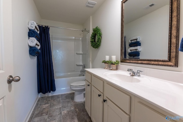 full bathroom with stone finish floor, vanity, visible vents, toilet, and baseboards