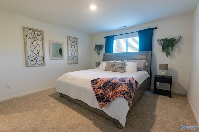 bedroom with visible vents, baseboards, and carpet