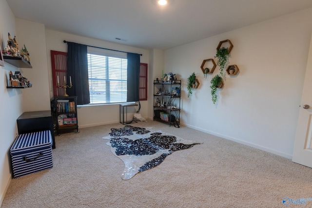 interior space with carpet flooring, visible vents, and baseboards