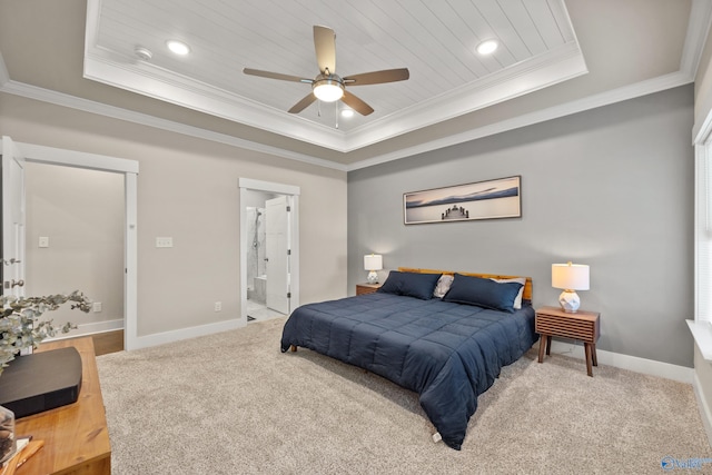 bedroom with crown molding, carpet flooring, a tray ceiling, and ceiling fan