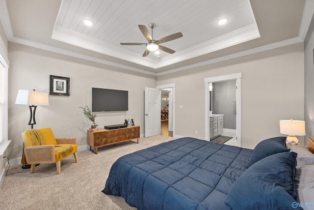 bedroom with ensuite bath, a raised ceiling, ceiling fan, crown molding, and light colored carpet