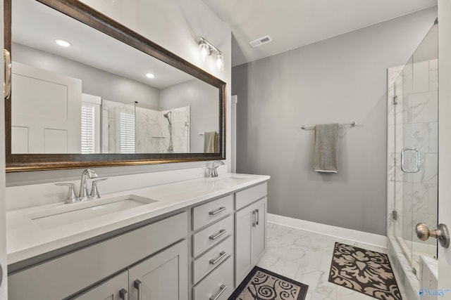 bathroom featuring vanity and an enclosed shower