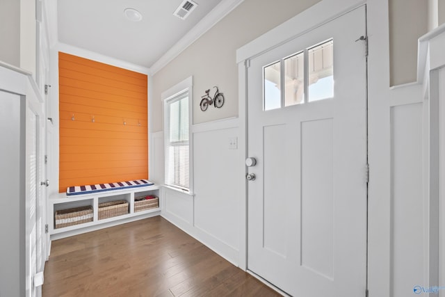 entrance foyer featuring dark wood-type flooring and crown molding