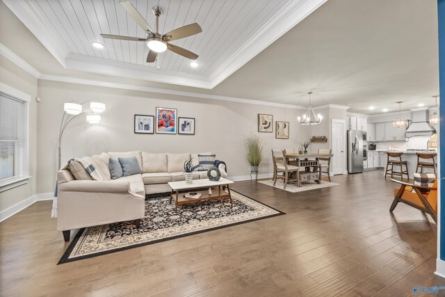 living room with dark hardwood / wood-style flooring, wooden ceiling, ceiling fan with notable chandelier, and a raised ceiling