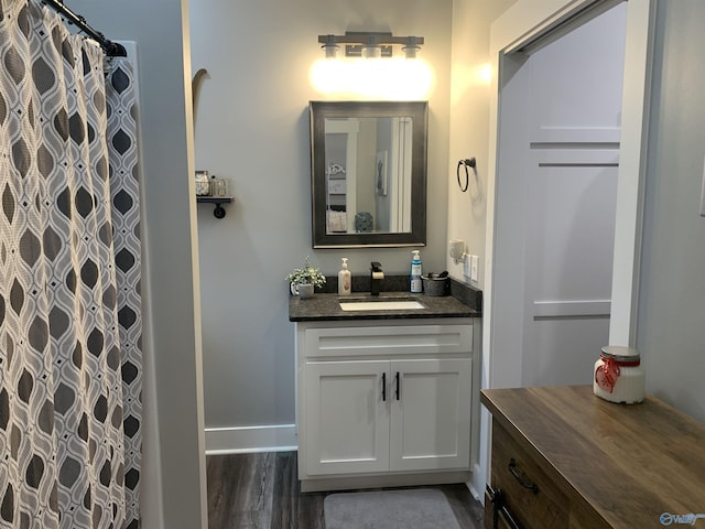 bathroom featuring vanity, hardwood / wood-style floors, and walk in shower