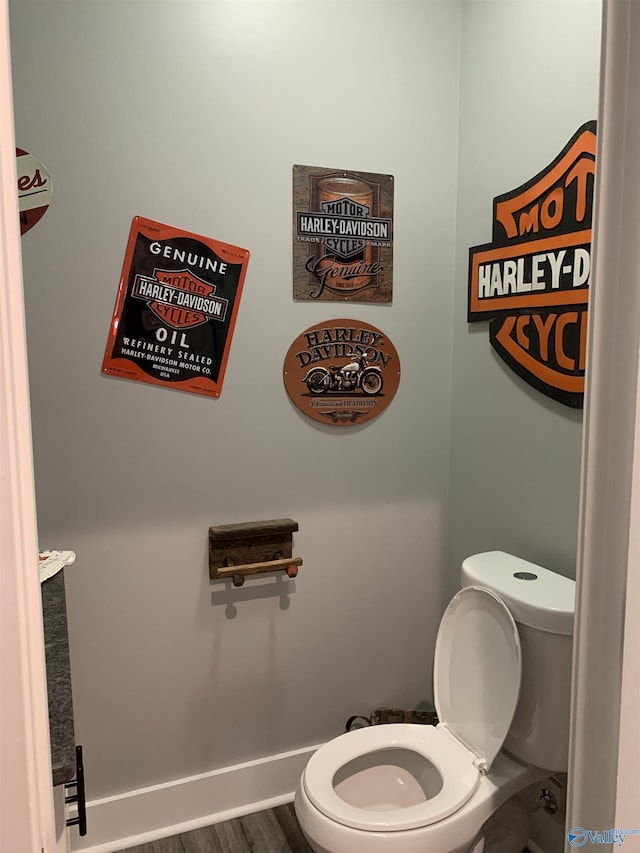 bathroom featuring hardwood / wood-style floors and toilet