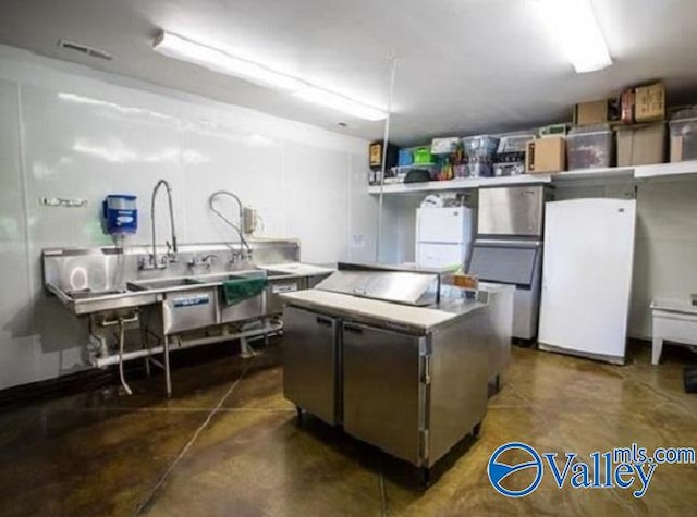 kitchen with a center island and white fridge