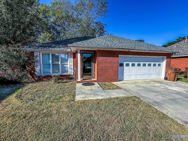 ranch-style home with a front yard and a garage