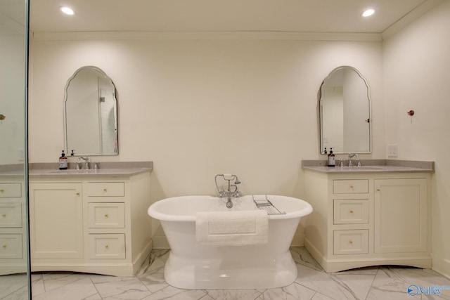 bathroom with vanity, a tub to relax in, and crown molding