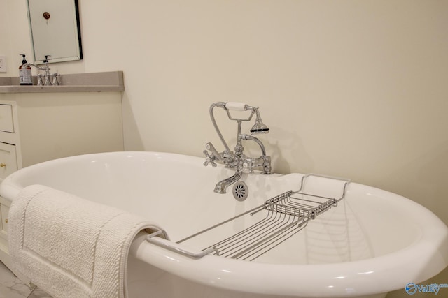 interior details with vanity and a tub