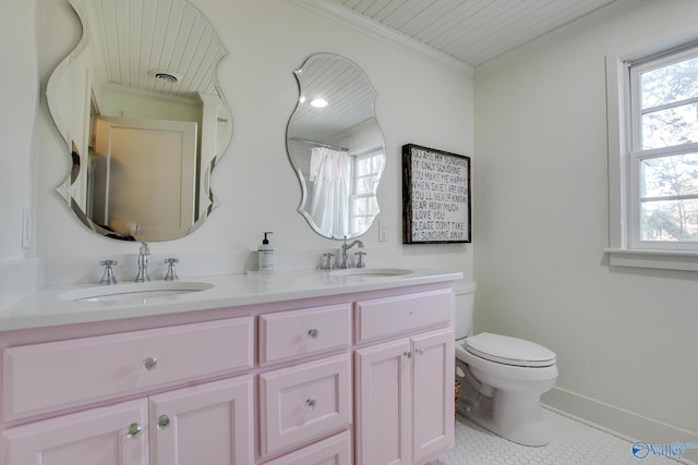 bathroom with crown molding, vanity, toilet, and tile patterned flooring