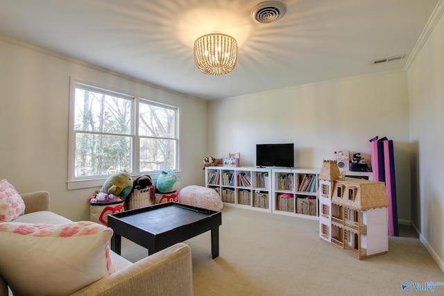 recreation room featuring ornamental molding, a chandelier, and carpet