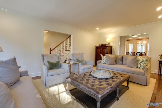 living room with hardwood / wood-style floors, crown molding, and a chandelier