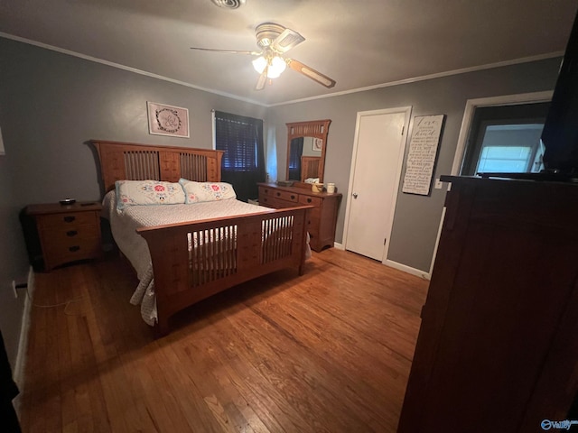 bedroom with crown molding, ceiling fan, and hardwood / wood-style flooring