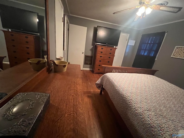 bedroom featuring ornamental molding, wood-type flooring, and ceiling fan