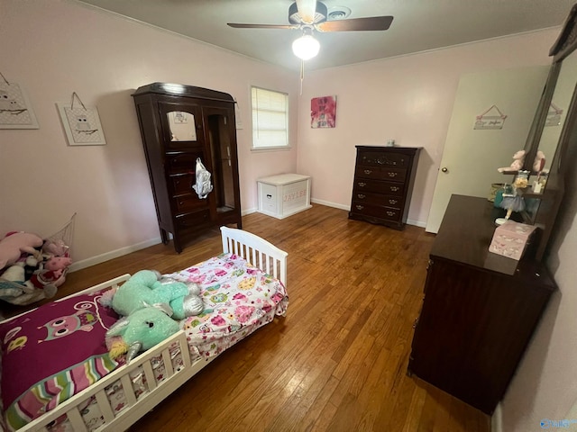 bedroom with hardwood / wood-style floors and ceiling fan