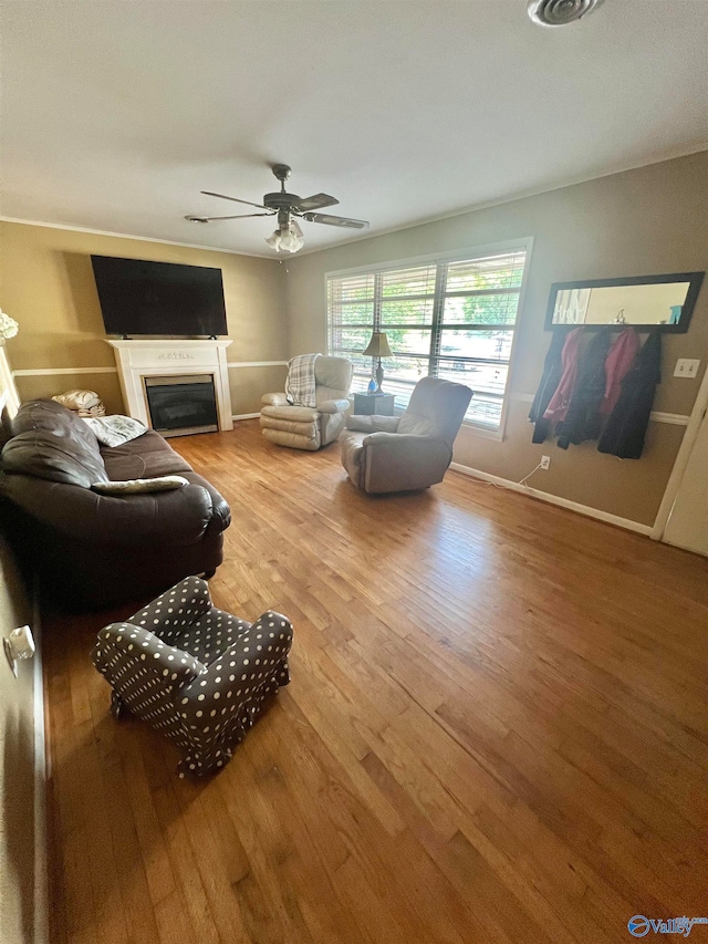 living room featuring wood-type flooring and ceiling fan