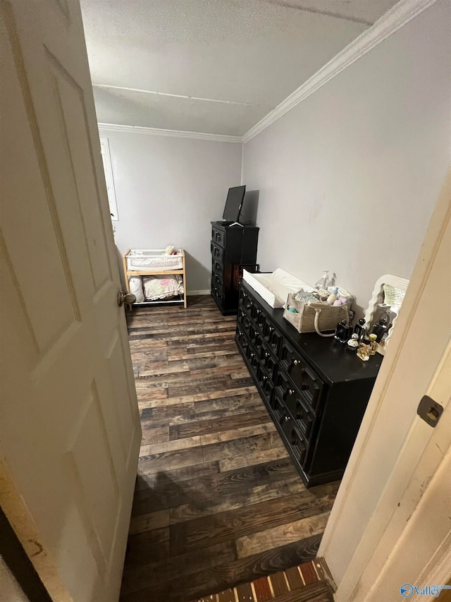 interior space with ornamental molding, dark hardwood / wood-style flooring, and a textured ceiling