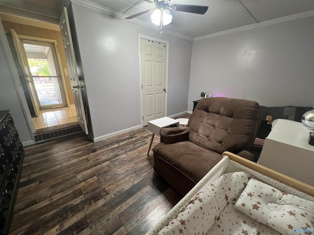 interior space featuring dark wood-type flooring, ceiling fan, and ornamental molding