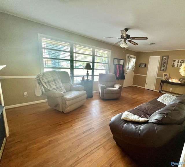 living room with light wood-type flooring and ceiling fan