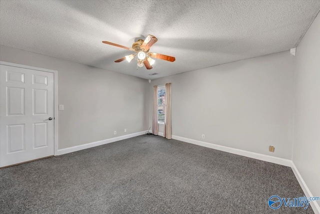 spare room with dark colored carpet, ceiling fan, and a textured ceiling