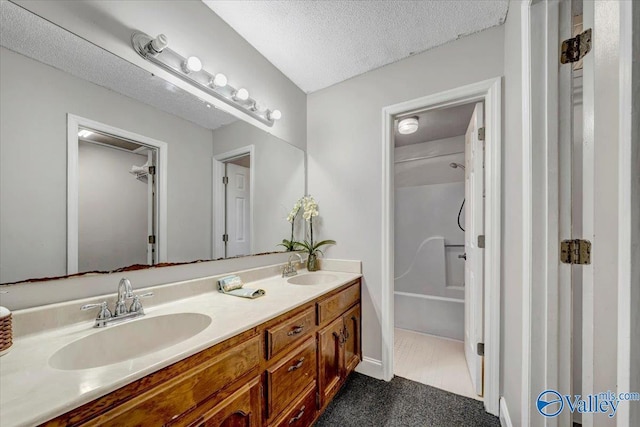 bathroom with vanity and a textured ceiling