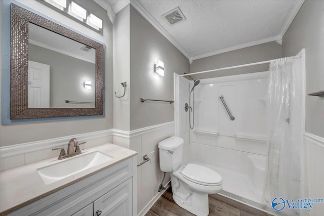 bathroom featuring wood-type flooring, a textured ceiling, and ornamental molding