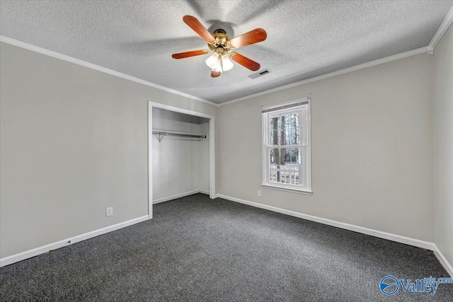 unfurnished bedroom with a closet, dark carpet, ceiling fan, and ornamental molding