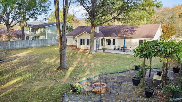 rear view of property with a patio and a yard