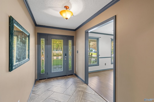 doorway to outside featuring light wood-type flooring, a textured ceiling, and ornamental molding