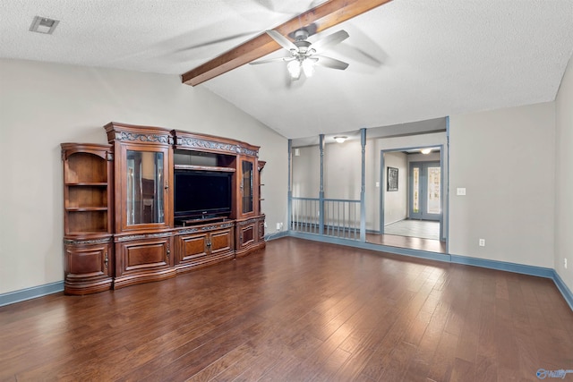 unfurnished living room featuring lofted ceiling with beams, ceiling fan, a textured ceiling, and dark hardwood / wood-style flooring