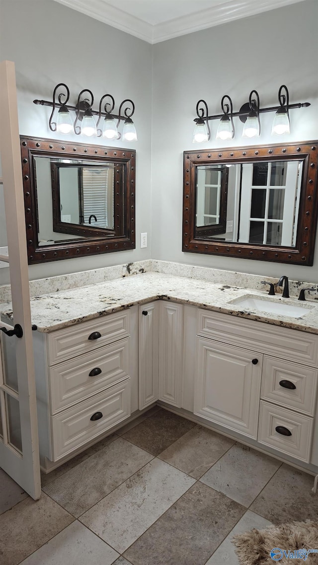 bathroom with crown molding and vanity