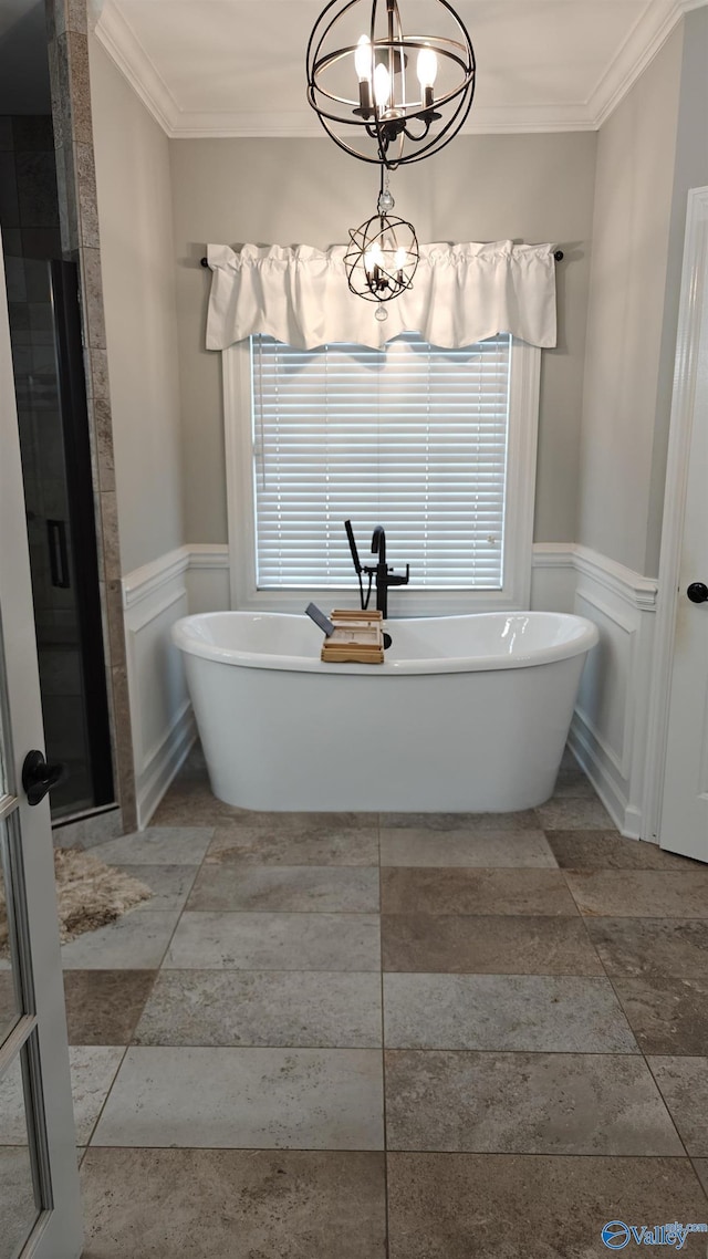 bathroom with independent shower and bath, ornamental molding, and a chandelier