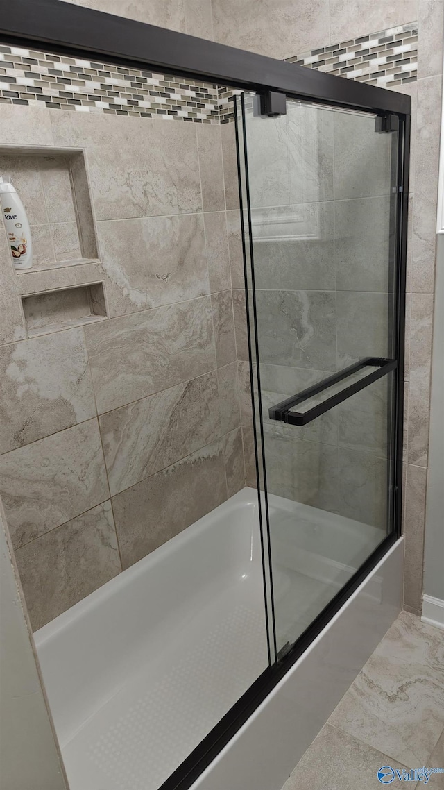 bathroom featuring shower / bath combination with glass door