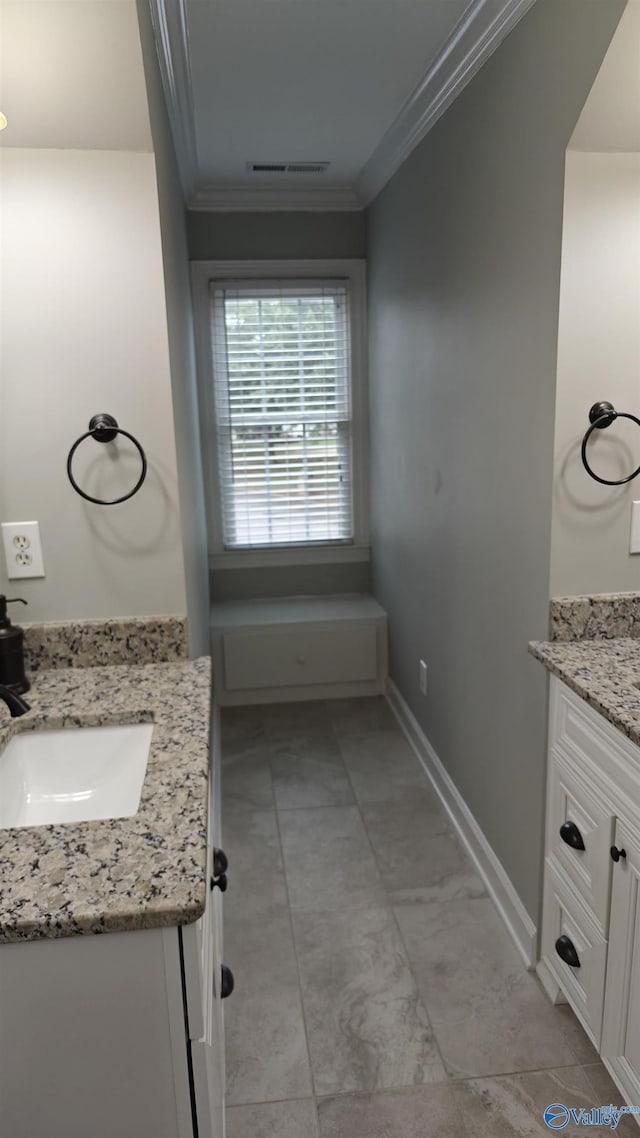 bathroom with ornamental molding and vanity