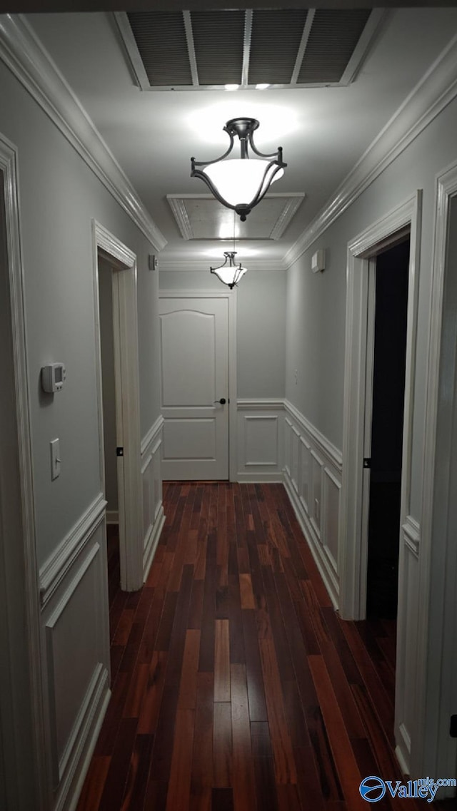 corridor with ornamental molding and dark hardwood / wood-style floors