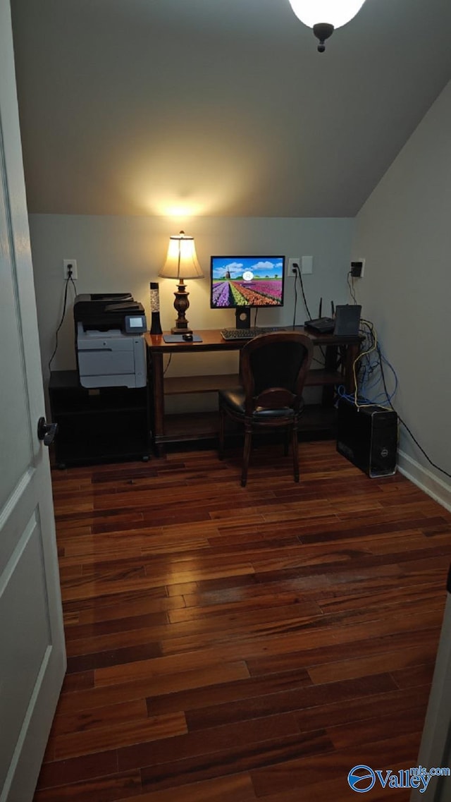 office featuring vaulted ceiling and dark wood-type flooring