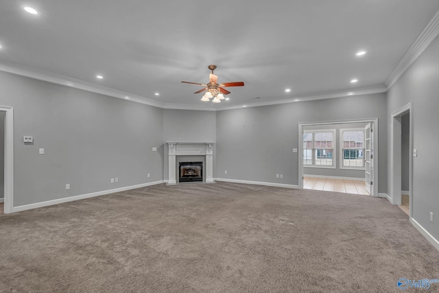 unfurnished living room with ceiling fan, crown molding, and light colored carpet