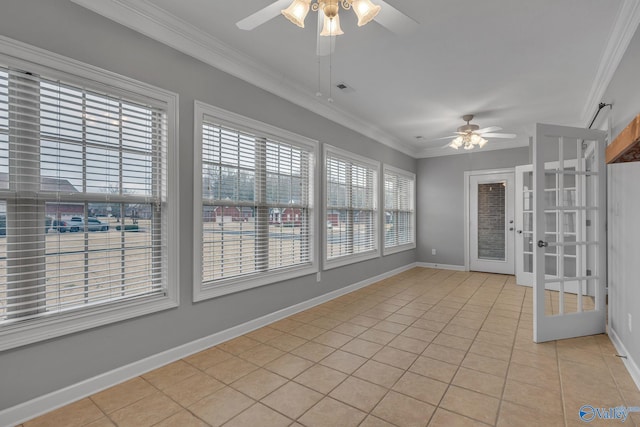 unfurnished sunroom featuring ceiling fan and french doors