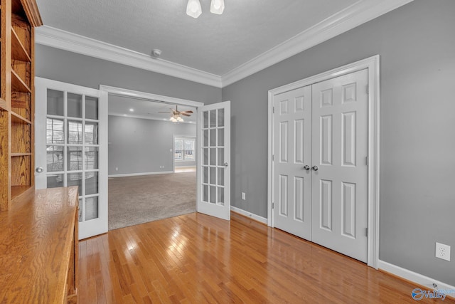 spare room featuring ceiling fan, ornamental molding, and french doors