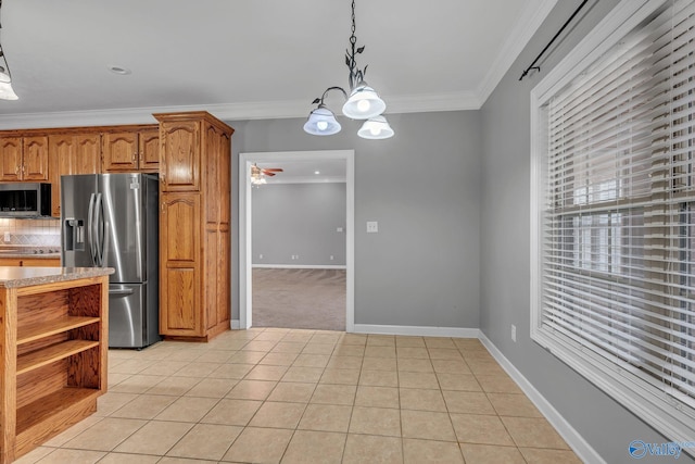 kitchen featuring pendant lighting, stainless steel appliances, light tile patterned floors, and crown molding