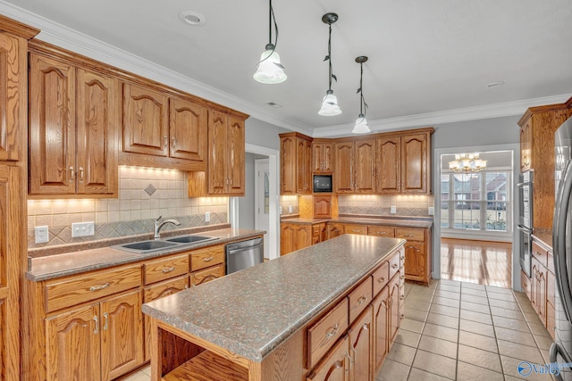 kitchen featuring a center island, sink, ornamental molding, light tile patterned flooring, and stainless steel appliances