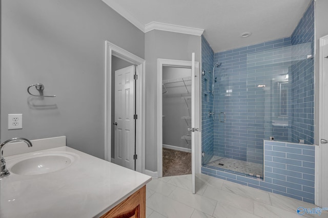 bathroom with vanity, a shower with door, and crown molding