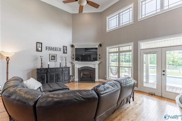 14690 Birchbark St, Athens, AL 35613 - living room featuring a wealth of natural light, a ceiling fan, light wood-type flooring, and a towering ceiling