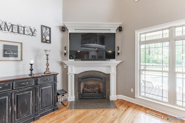14690 Birchbark St, Athens, AL 35613 - living area featuring baseboards, visible vents, a fireplace with flush hearth, and wood finished floors