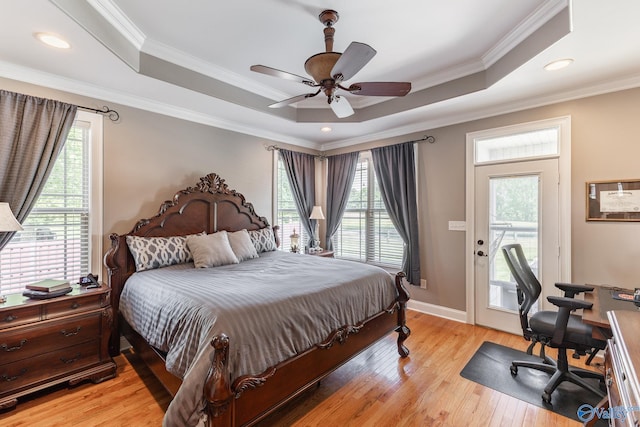 14690 Birchbark St, Athens, AL 35613 - bedroom with light wood-style floors, multiple windows, a raised ceiling, and access to exterior